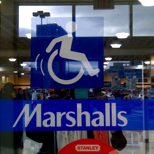 The sliding doors at Marshalls have a wheelchair-riding icon that shows the figure moving through space, with motion lines to show its movement.